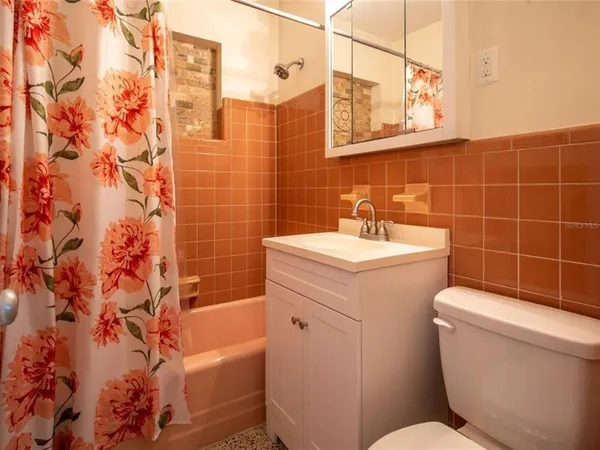 a bathroom with a sink toilet and shower