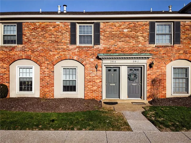 front view of a brick house with a window