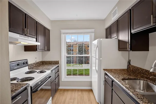 a kitchen with a stove a sink and a refrigerator