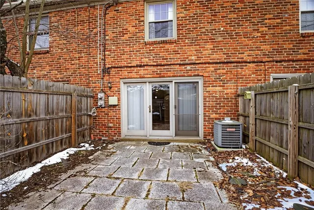 a view of a brick wall with an outdoor space