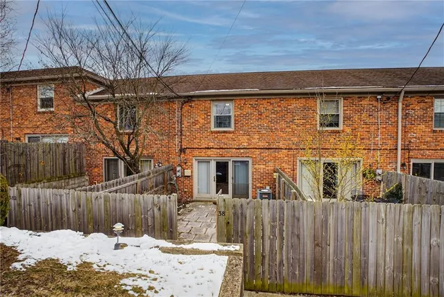 a view of a house with a wooden fence