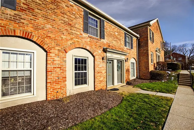 a view of a brick house with many windows