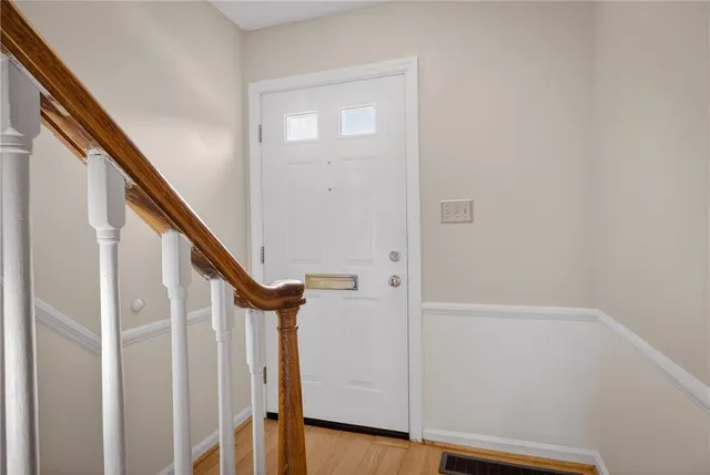 a view of staircase with railing and white walls