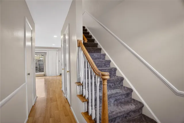 a view of a hallway with wooden floor and entryway