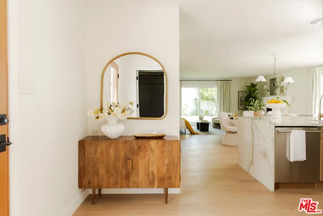 a view of living room with furniture and mirror
