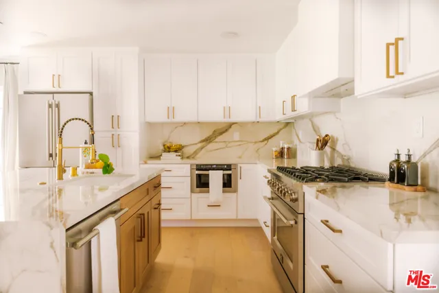 a kitchen with a stove a sink and a refrigerator