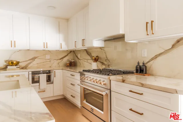 a kitchen with white cabinets and white appliances