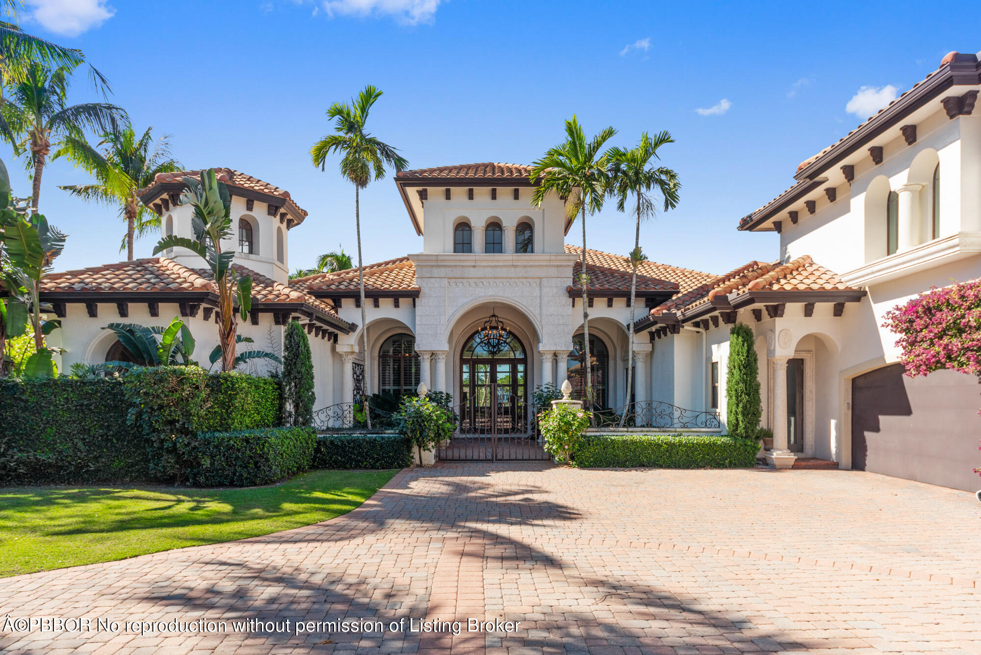 314 West Riverside Drive Jupiter, FL 33469 - Photo 5 of 92 a front view of a house with a garden and a yard