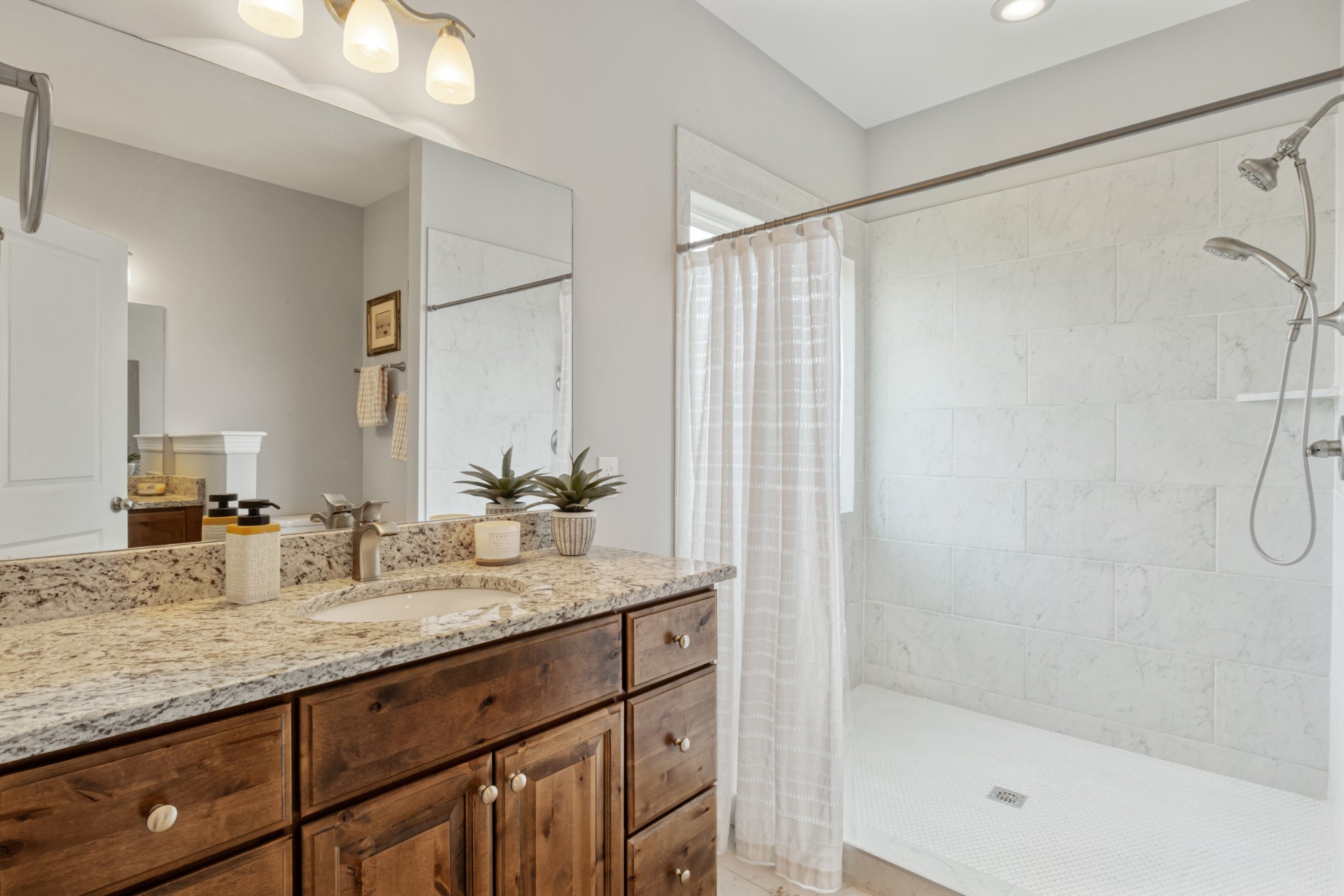2264 Blackwell Road Chapel Hill, TN 37034 - Photo 10 of 18 a bathroom with a granite countertop sink a mirror and a shower