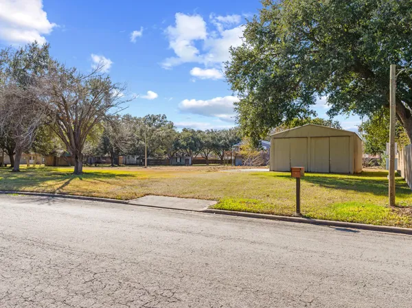a view of swimming pool with trees in the background