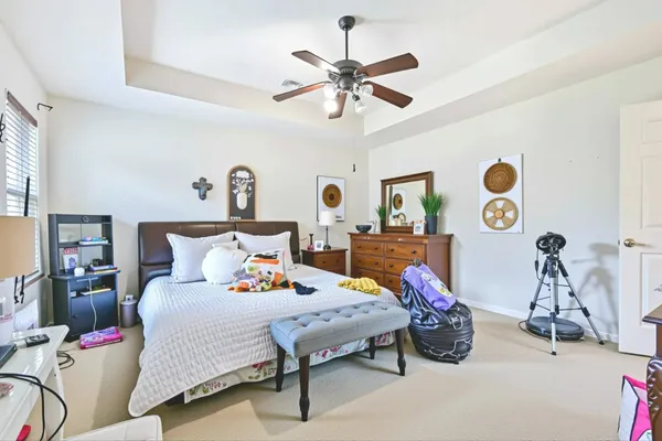 a bedroom with bed and a chandelier