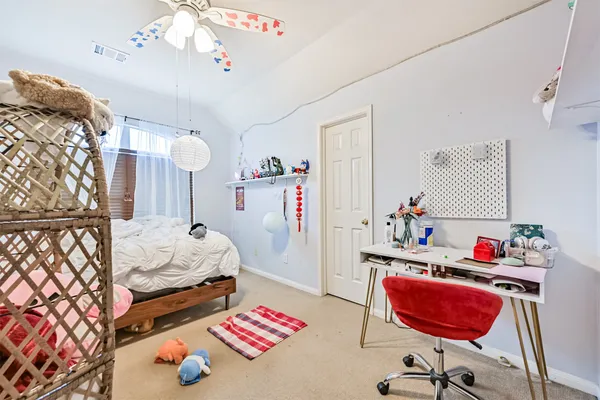 a bedroom with furniture and a window