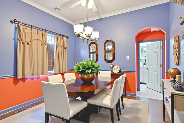 a dining room with furniture potted plants and a chandelier