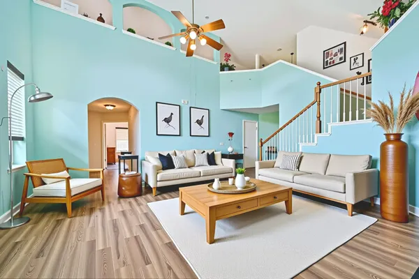 a living room with furniture and wooden floor