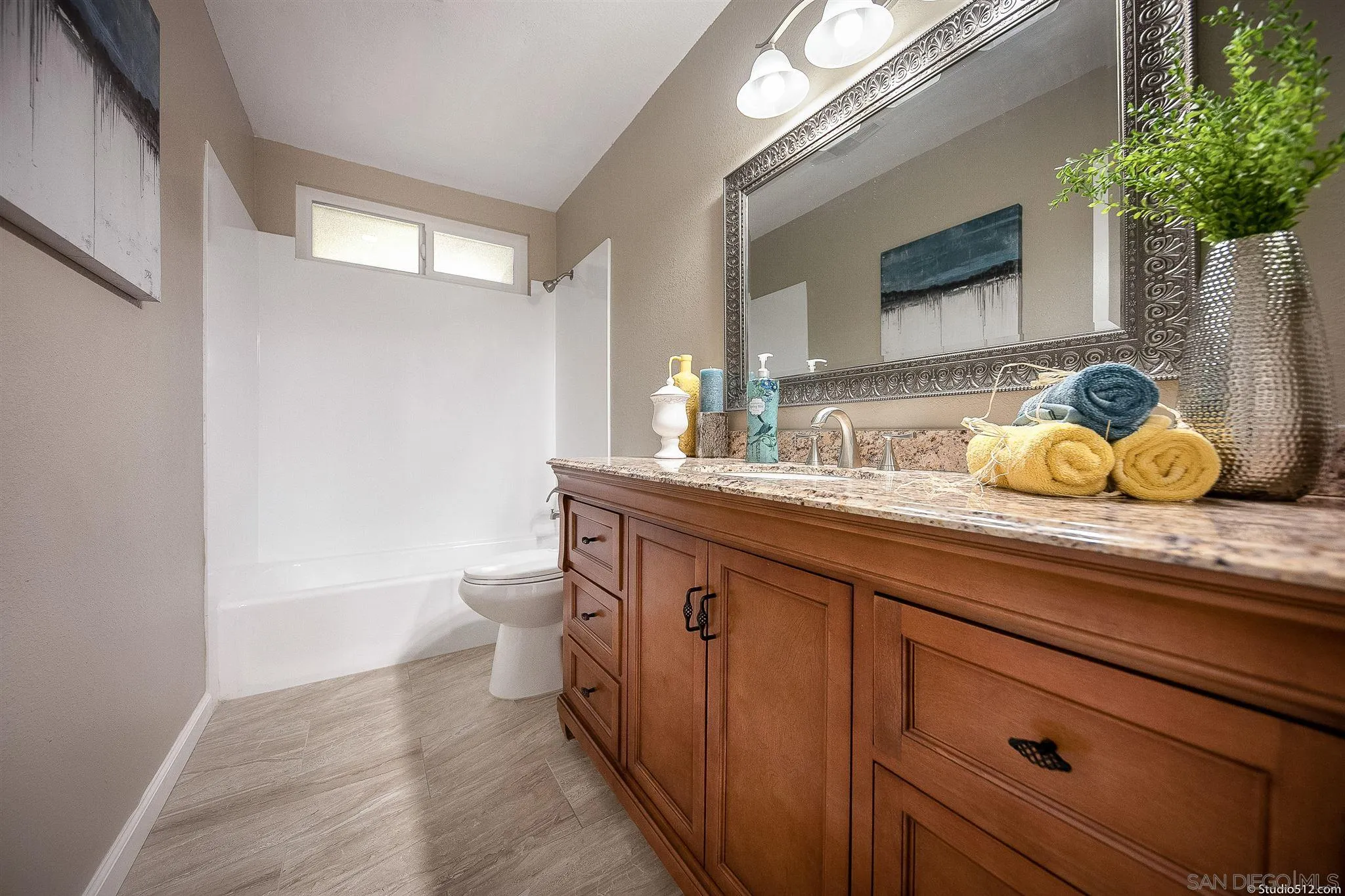 11425 Betsworth Road Valley Center, CA 92082 - Photo 15 of 24 a bathroom with a granite countertop sink a toilet and mirror