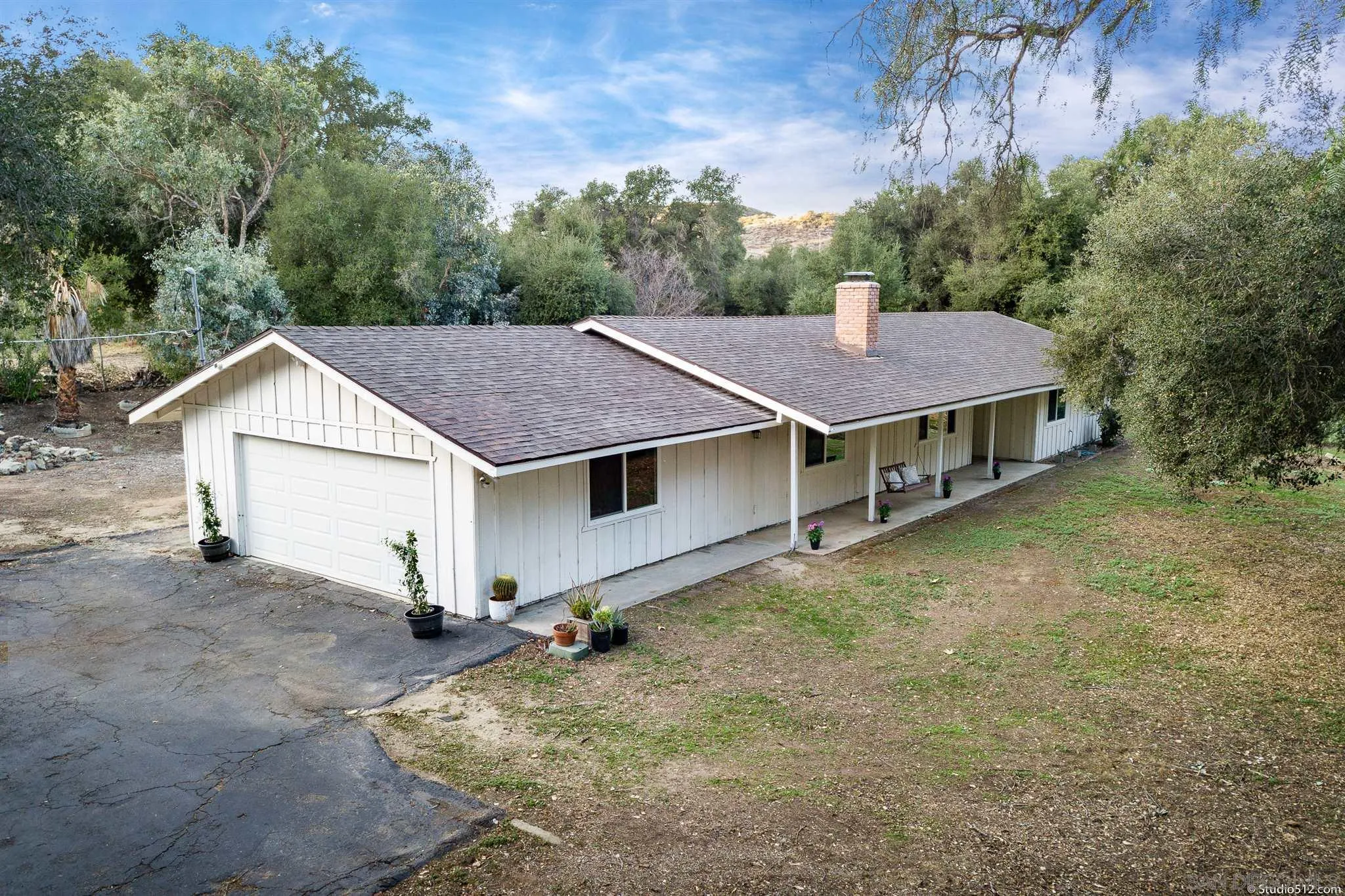 11425 Betsworth Road Valley Center, CA 92082 - Photo 20 of 24 a view of a house with a yard balcony and wooden fence