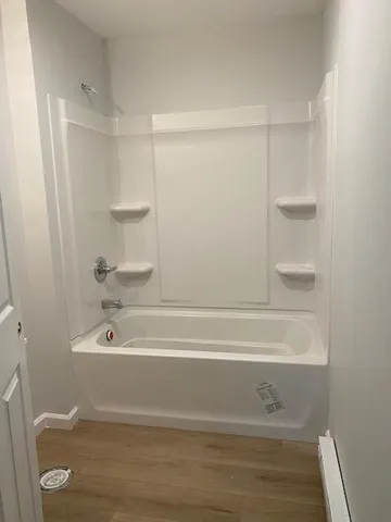 a bathroom with a bathtub and a toilet