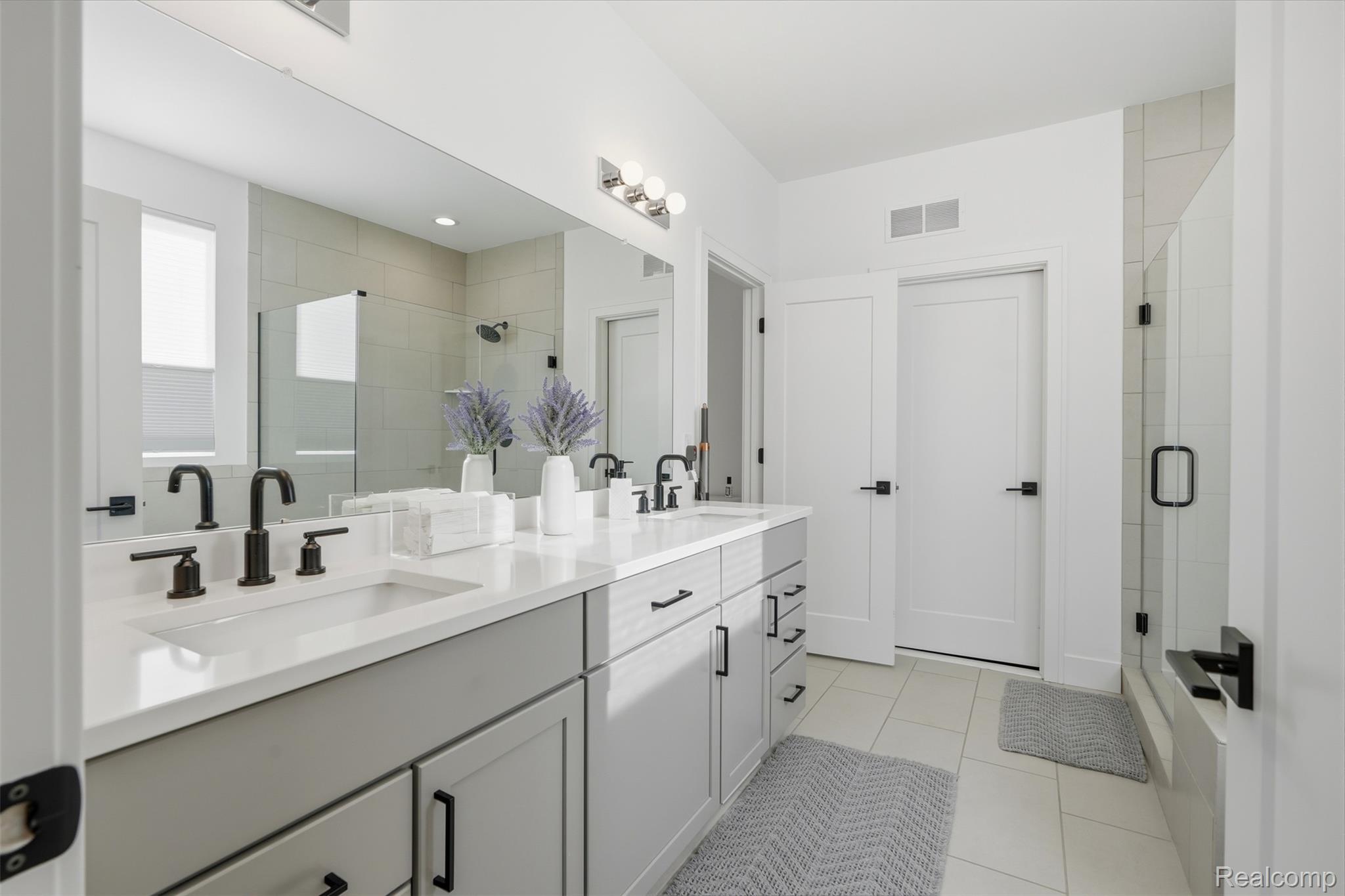 2556 Rosemond Lane Rochester, MI 48309 - Photo 21 of 64 Bathroom featuring double vanity, a stall shower, and light tile patterned floors