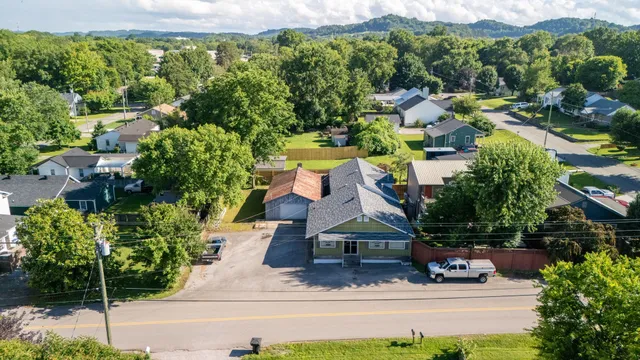 an aerial view of a house with a yard basket ball court and outdoor seating