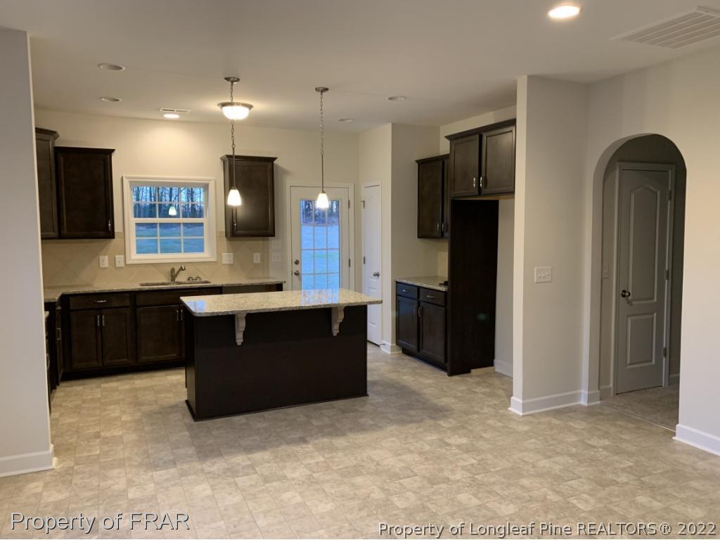 865 Montrose Road Raeford, NC 28376 - Photo 11 of 21 a kitchen with a refrigerator and a sink