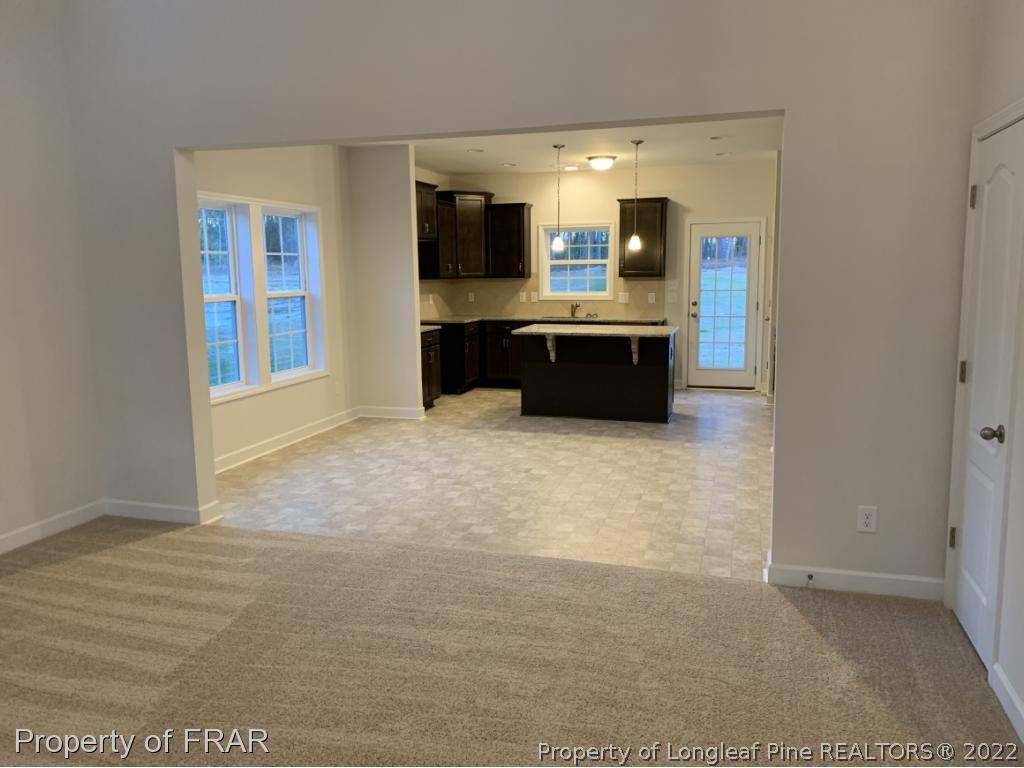 865 Montrose Road Raeford, NC 28376 - Photo 4 of 21 a kitchen with kitchen island granite countertop a sink and cabinets