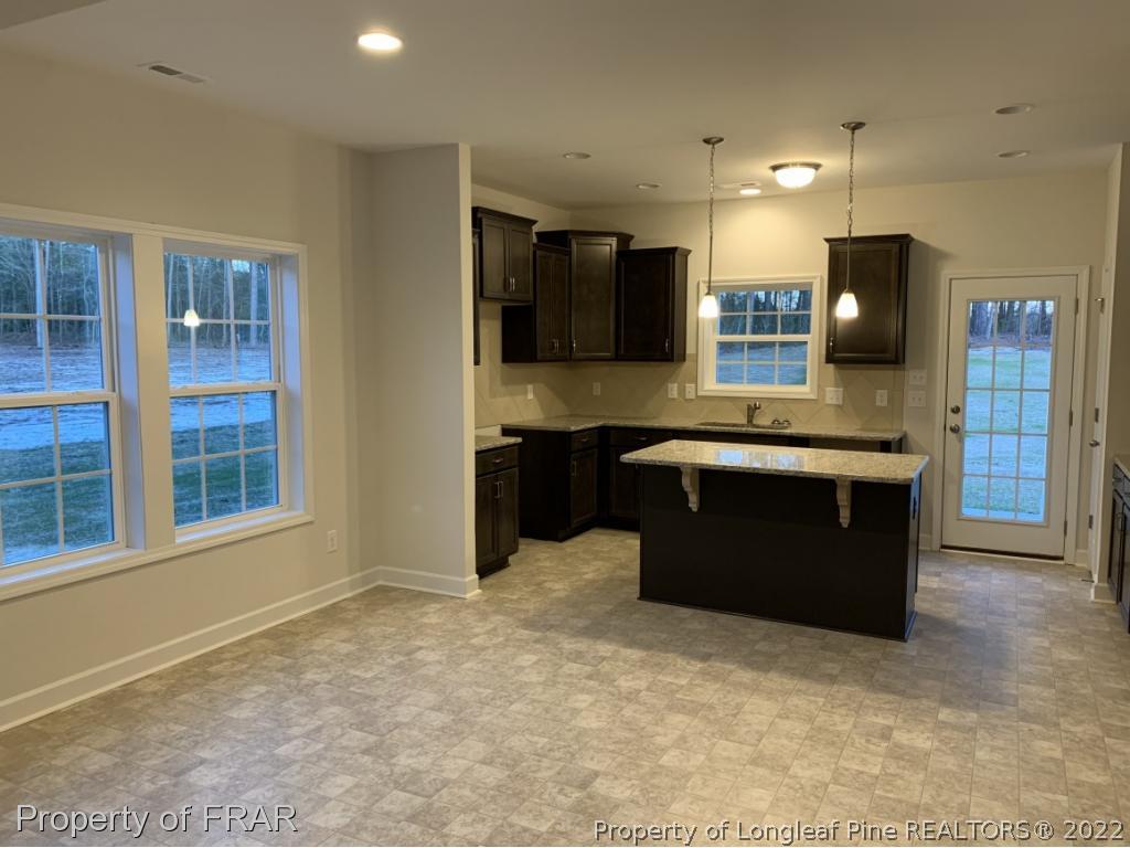 865 Montrose Road Raeford, NC 28376 - Photo 10 of 21 a kitchen with stainless steel appliances granite countertop a stove a sink and a refrigerator
