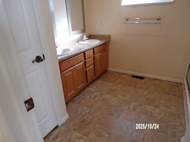 a bathroom with a sink and mirror