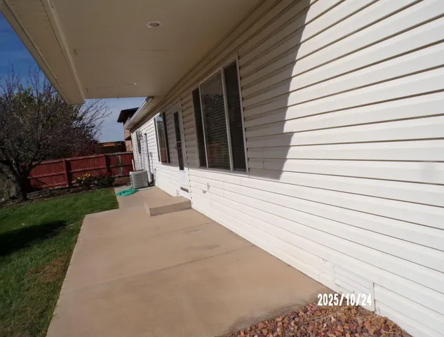 a view of backyard with potted plants and a bench