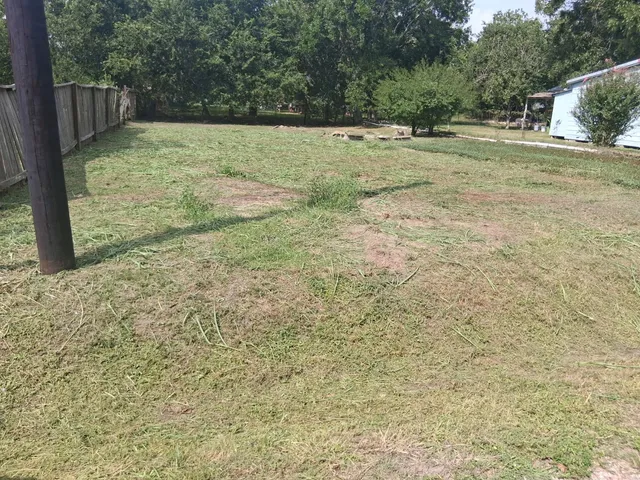 a view of a field with trees in the background