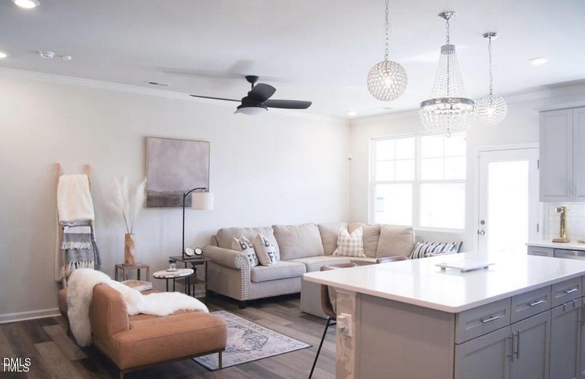 5006 Tura Street Raleigh, NC 27610 - Photo 12 of 32 a living room with furniture and a chandelier
