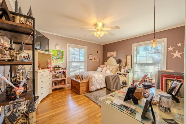 a bedroom with furniture and a large window