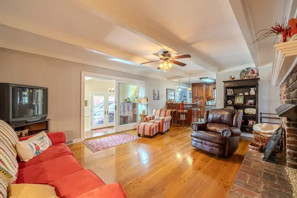 a living room with furniture gym equipment and a flat screen tv