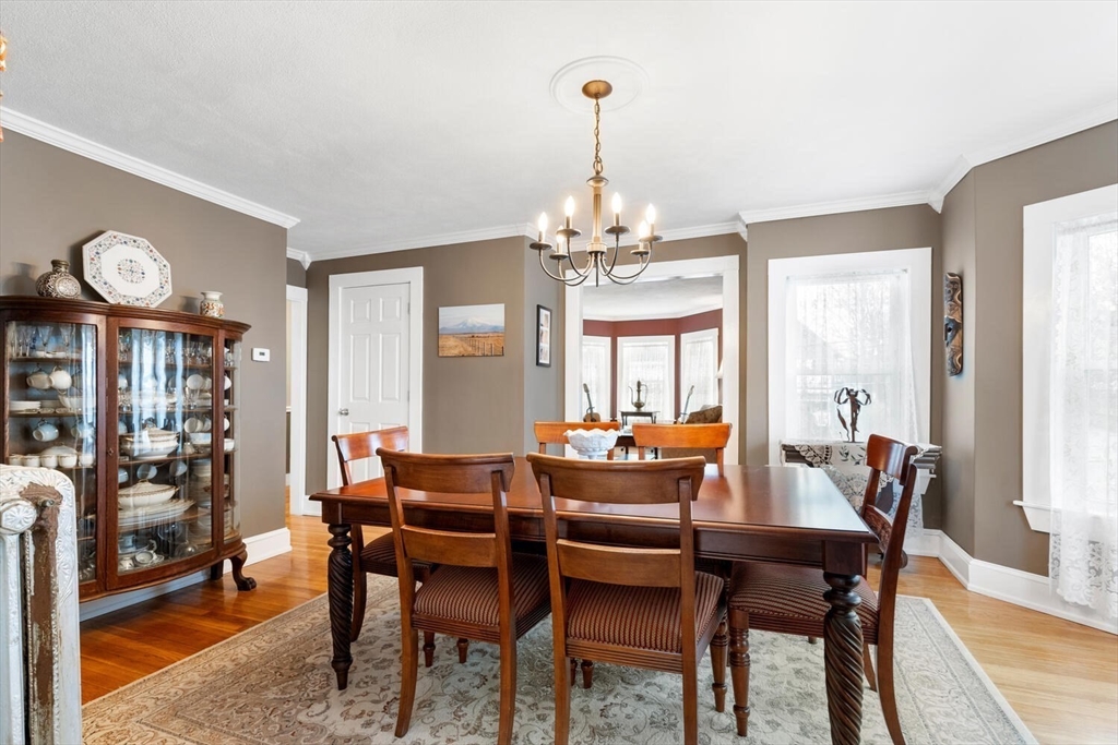 687 Main Street Wakefield, MA 01880 - Photo 13 of 36 a dining room with furniture a chandelier and wooden floor
