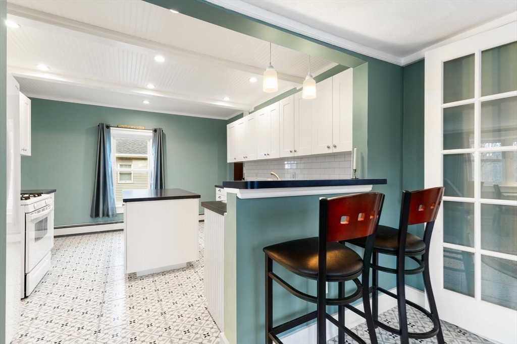 687 Main Street Wakefield, MA 01880 - Photo 18 of 36 a living room with furniture a dining table and kitchen view