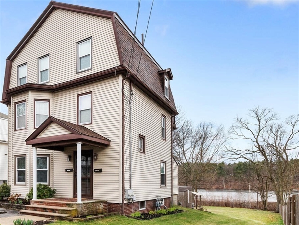 687 Main Street Wakefield, MA 01880 - Photo 2 of 36 a front view of a house with a yard
