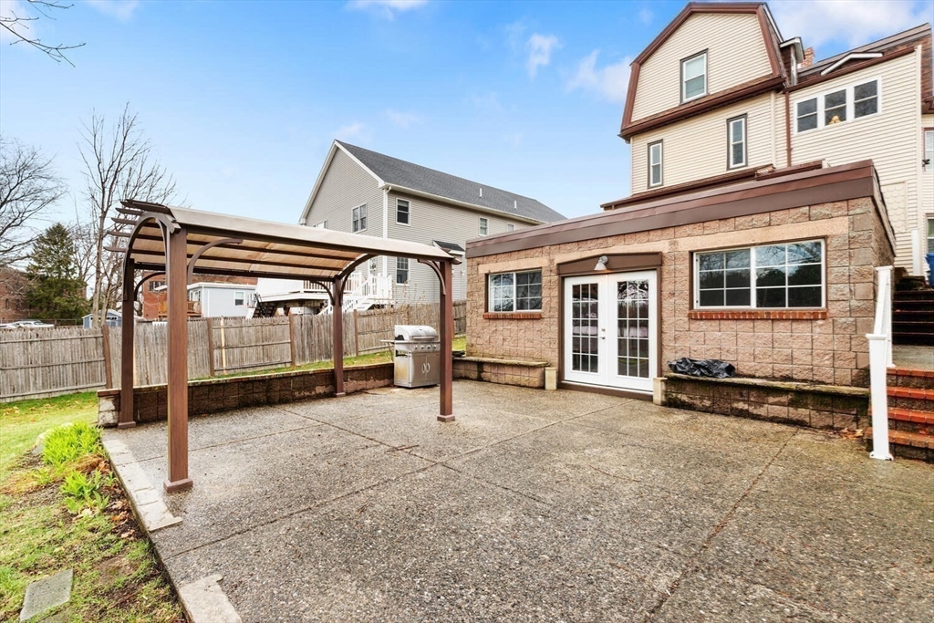 687 Main Street Wakefield, MA 01880 - Photo 32 of 36 front view of a house with a chair and table next to a road