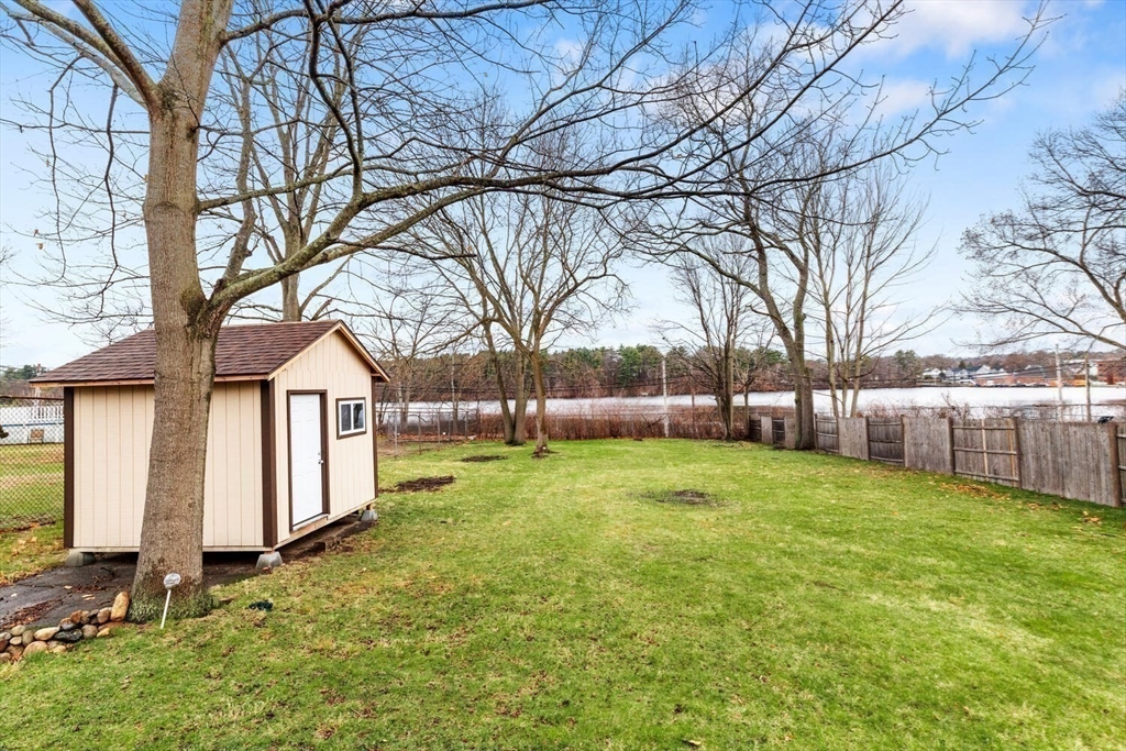 687 Main Street Wakefield, MA 01880 - Photo 36 of 36 a view of a yard with a house and a large tree