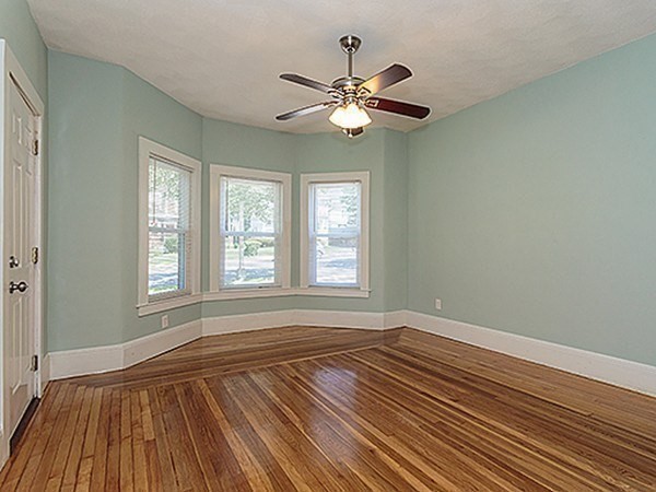687 Main Street Wakefield, MA 01880 - Photo 4 of 36 a view of an empty room with wooden floor and a window