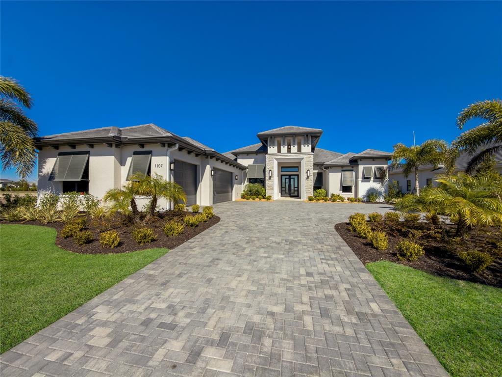1107 Blue Shell Loop Sarasota, FL 34240 - Photo 1 of 88 a front view of a house with a yard