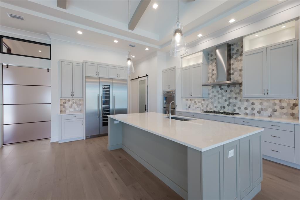1107 Blue Shell Loop Sarasota, FL 34240 - Photo 13 of 88 a large kitchen with kitchen island a sink a stove and refrigerator