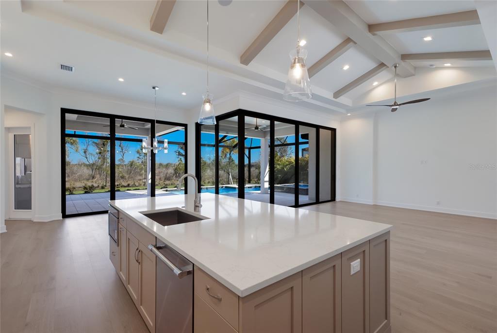 1107 Blue Shell Loop Sarasota, FL 34240 - Photo 15 of 88 a large hall with stainless steel appliances granite countertop a sink and a large window
