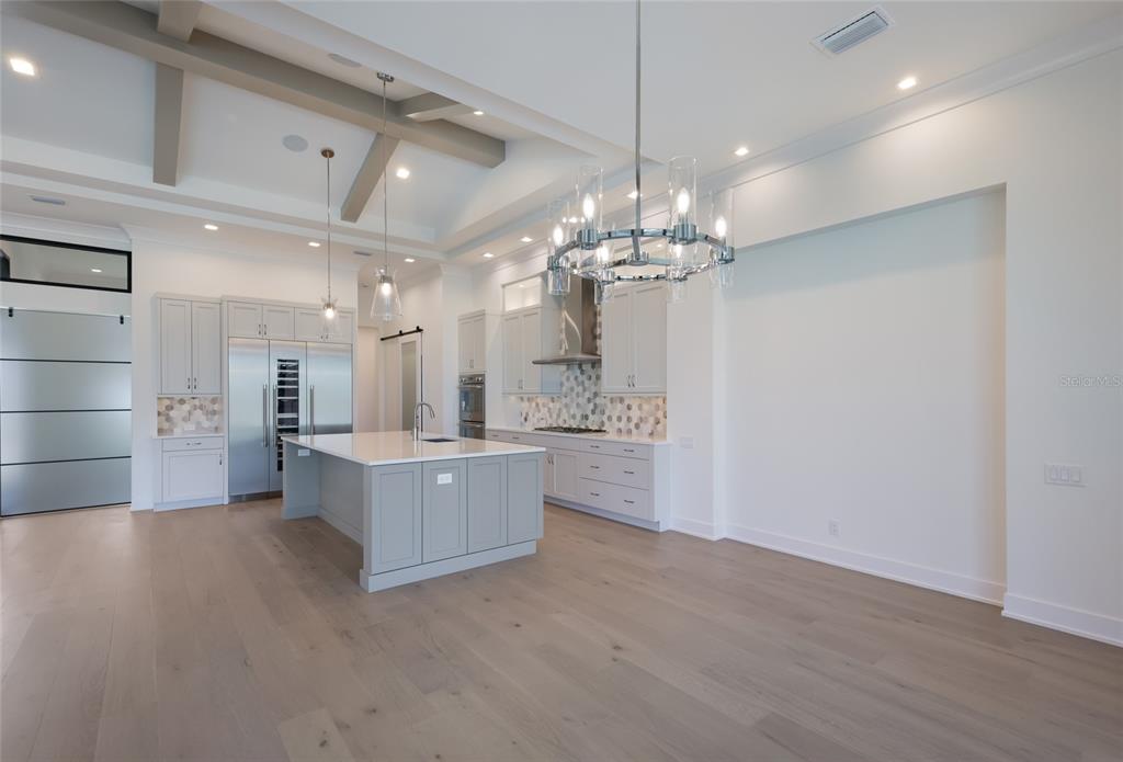1107 Blue Shell Loop Sarasota, FL 34240 - Photo 17 of 88 a large white kitchen with a chandelier