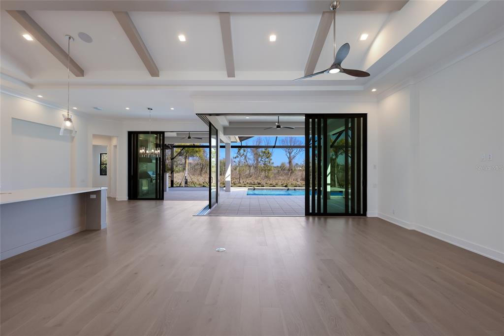 1107 Blue Shell Loop Sarasota, FL 34240 - Photo 19 of 88 an empty room with wooden floor and a fireplace