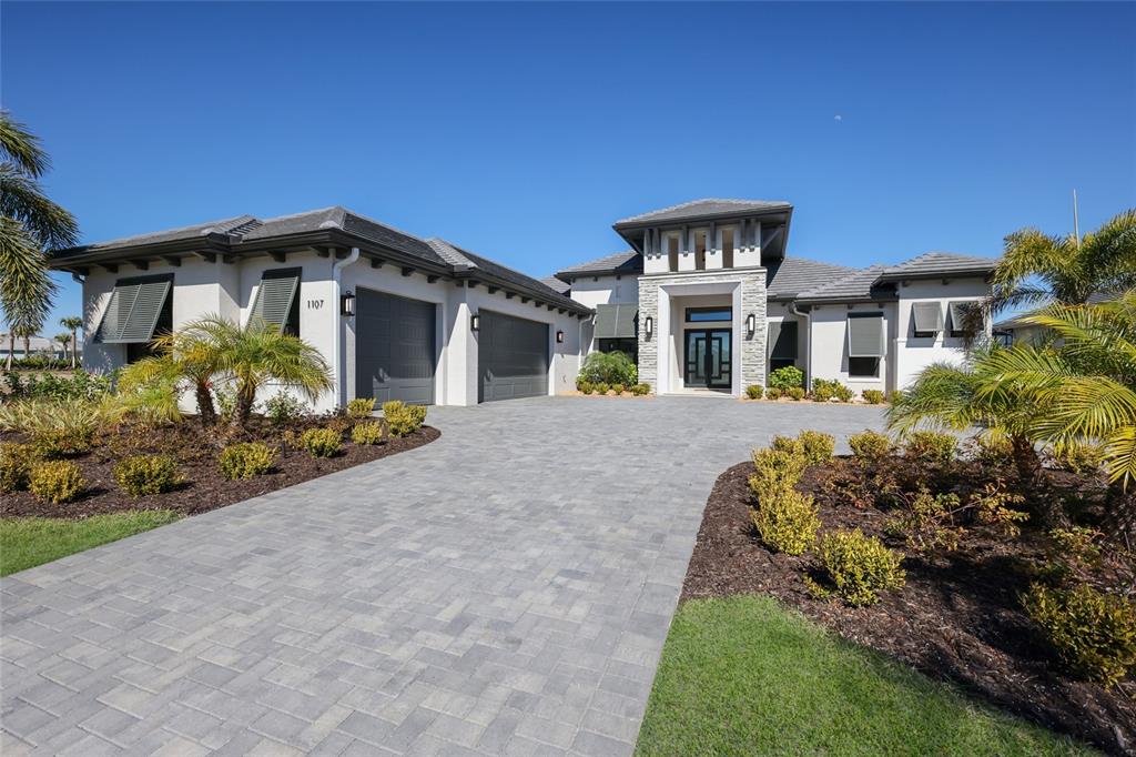 1107 Blue Shell Loop Sarasota, FL 34240 - Photo 2 of 88 a front view of a house with a yard and potted plants