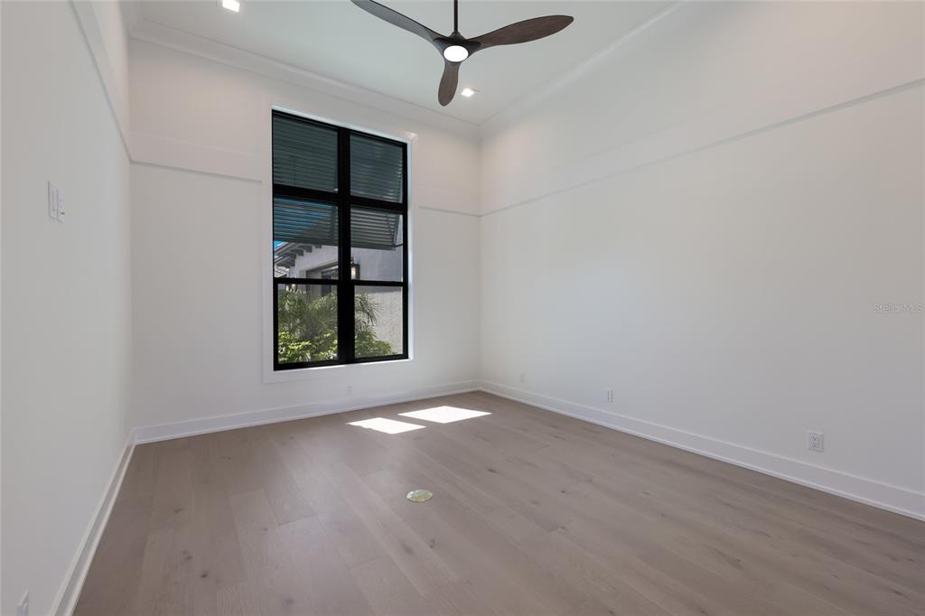 1107 Blue Shell Loop Sarasota, FL 34240 - Photo 23 of 88 an empty room with windows and ceiling fan