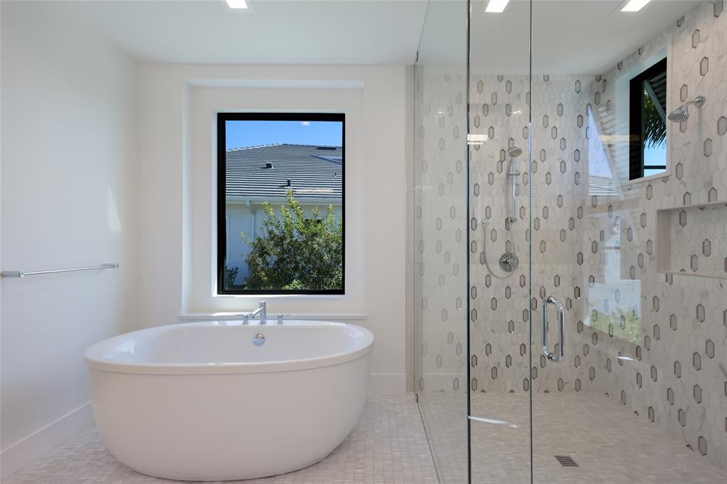 1107 Blue Shell Loop Sarasota, FL 34240 - Photo 34 of 88 a bathroom with a bathtub and a shower