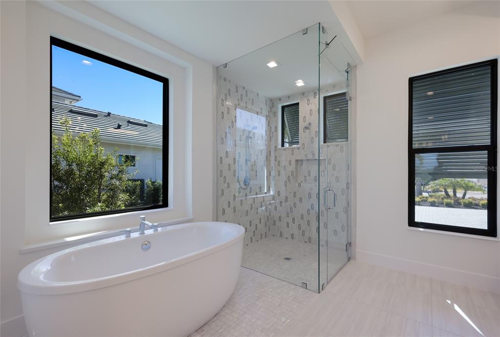 1107 Blue Shell Loop Sarasota, FL 34240 - Photo 35 of 88 a bathroom with a bathtub and a shower