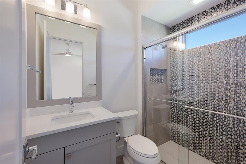 1107 Blue Shell Loop Sarasota, FL 34240 - Photo 44 of 88 a bathroom with a sink a toilet and shower