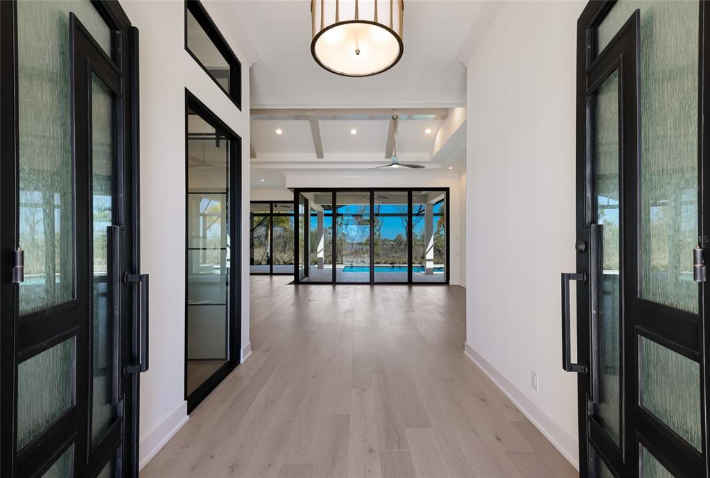 1107 Blue Shell Loop Sarasota, FL 34240 - Photo 5 of 88 a view of a hallway with wooden floor