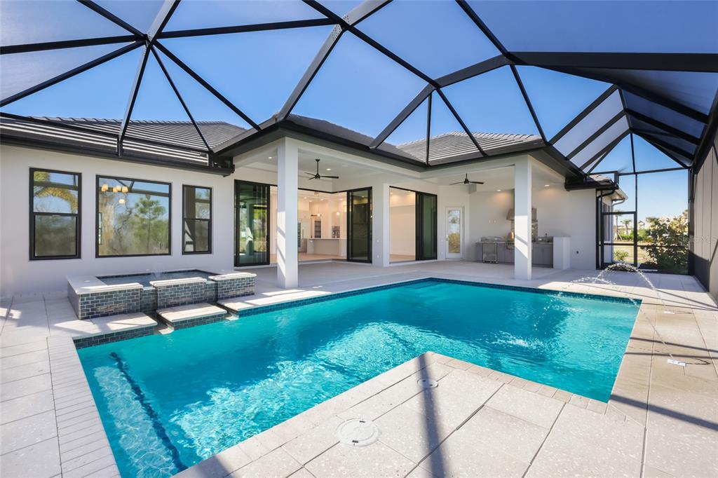 1107 Blue Shell Loop Sarasota, FL 34240 - Photo 51 of 88 a view of a patio with a table and chairs under an umbrella